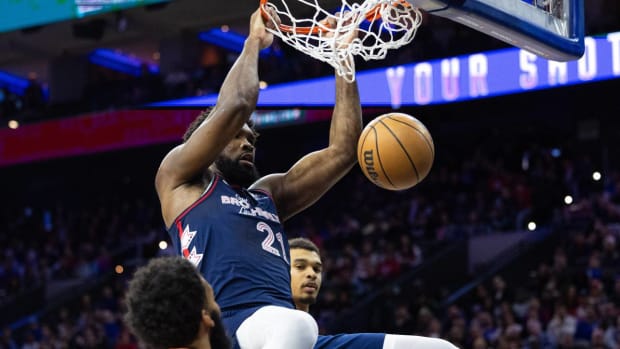 Joel Embiid dunks on the San Antonio Spurs.